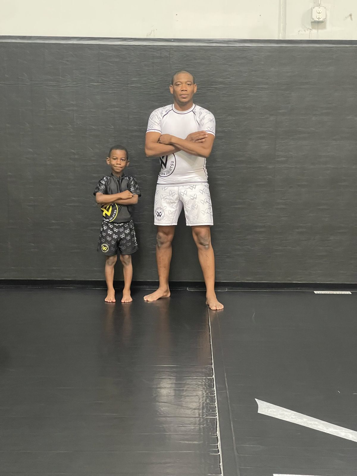 Professor Washington Luis with a young Little Ninjas student at Washington Luis Brazilian Jiu-Jitsu